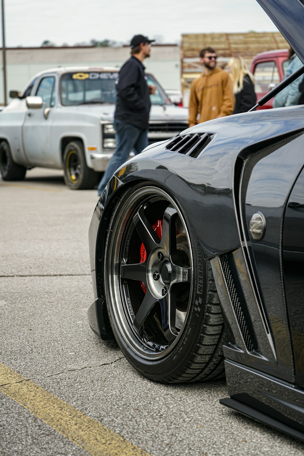 a black sports car parked in a parking lot