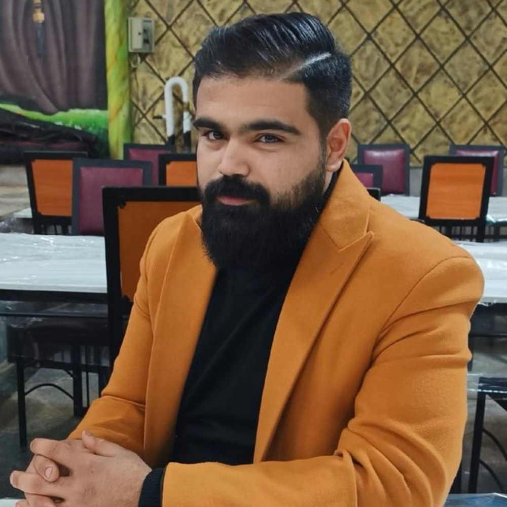 a man with a beard sitting at a table