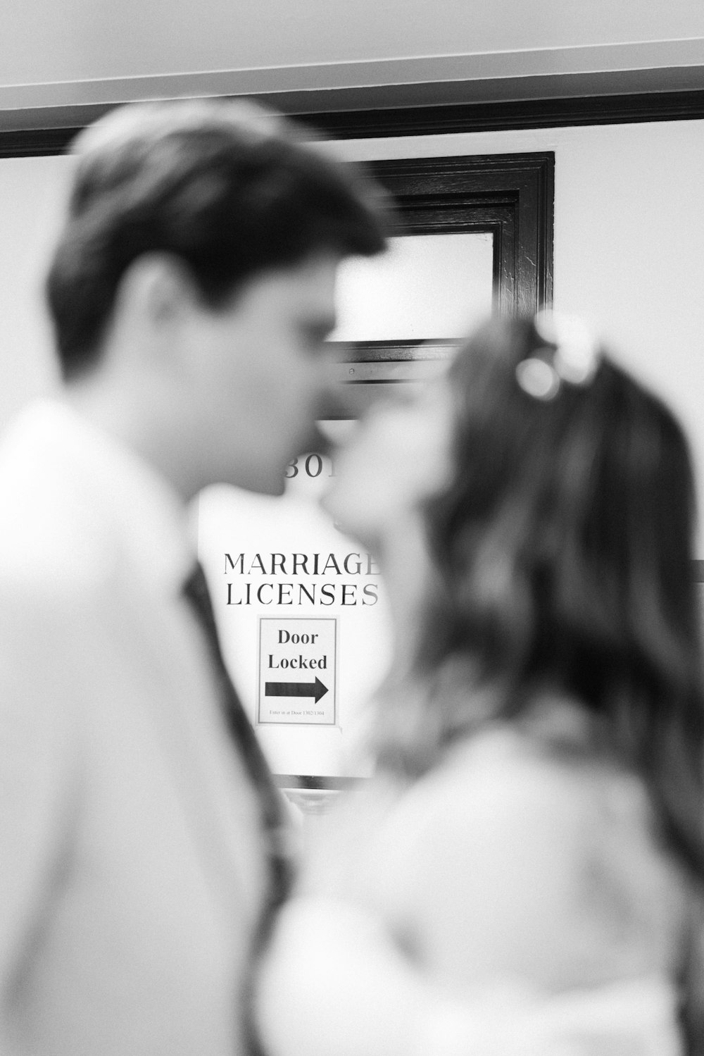 a man and a woman standing in front of a mirror