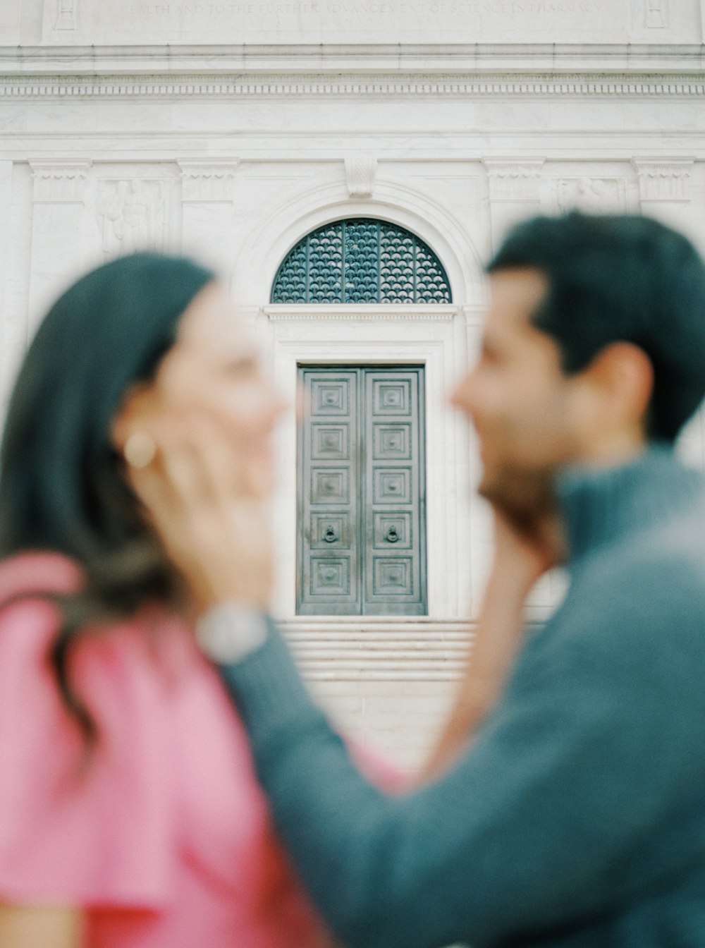 a man and a woman standing in front of a building