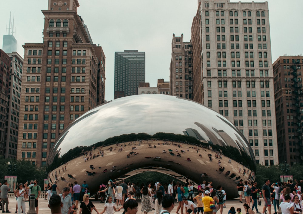 a group of people standing around a large metal object