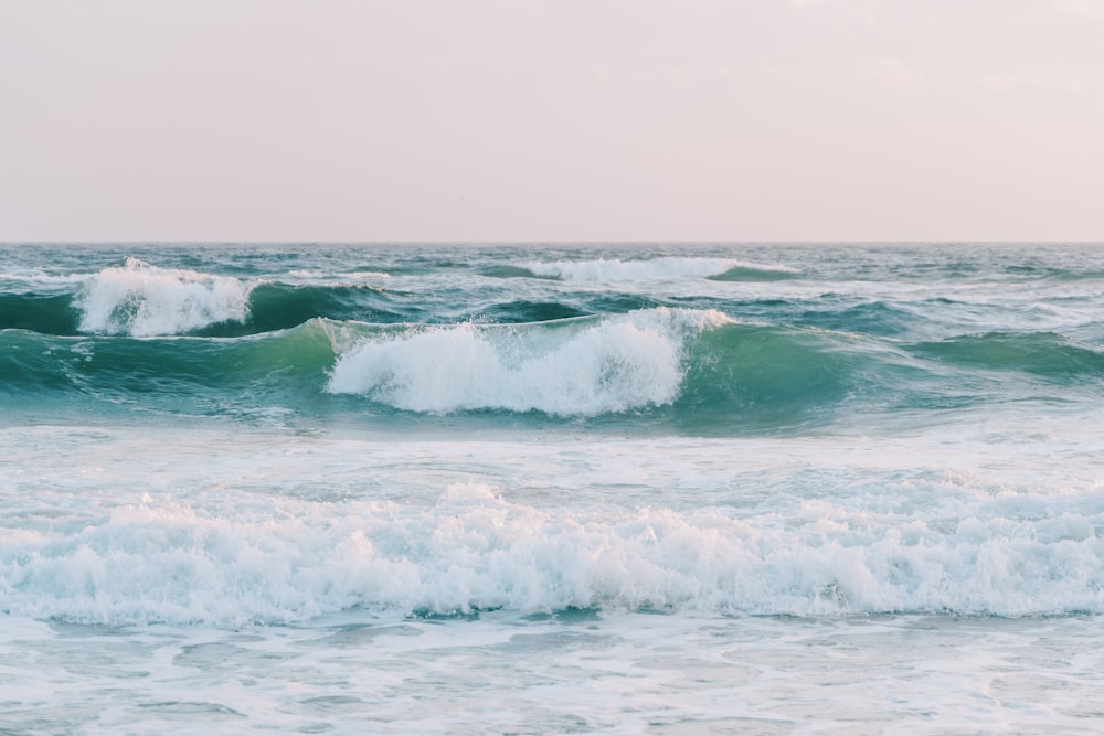 a person riding a surfboard on a wave in the ocean