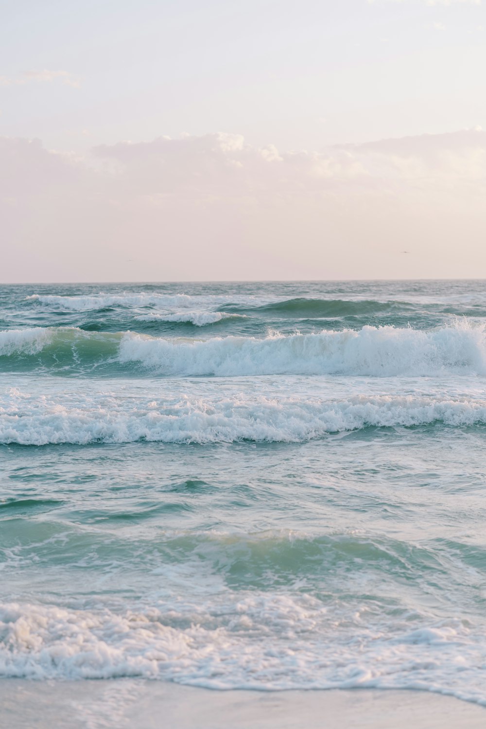 a person riding a surfboard on a wave in the ocean