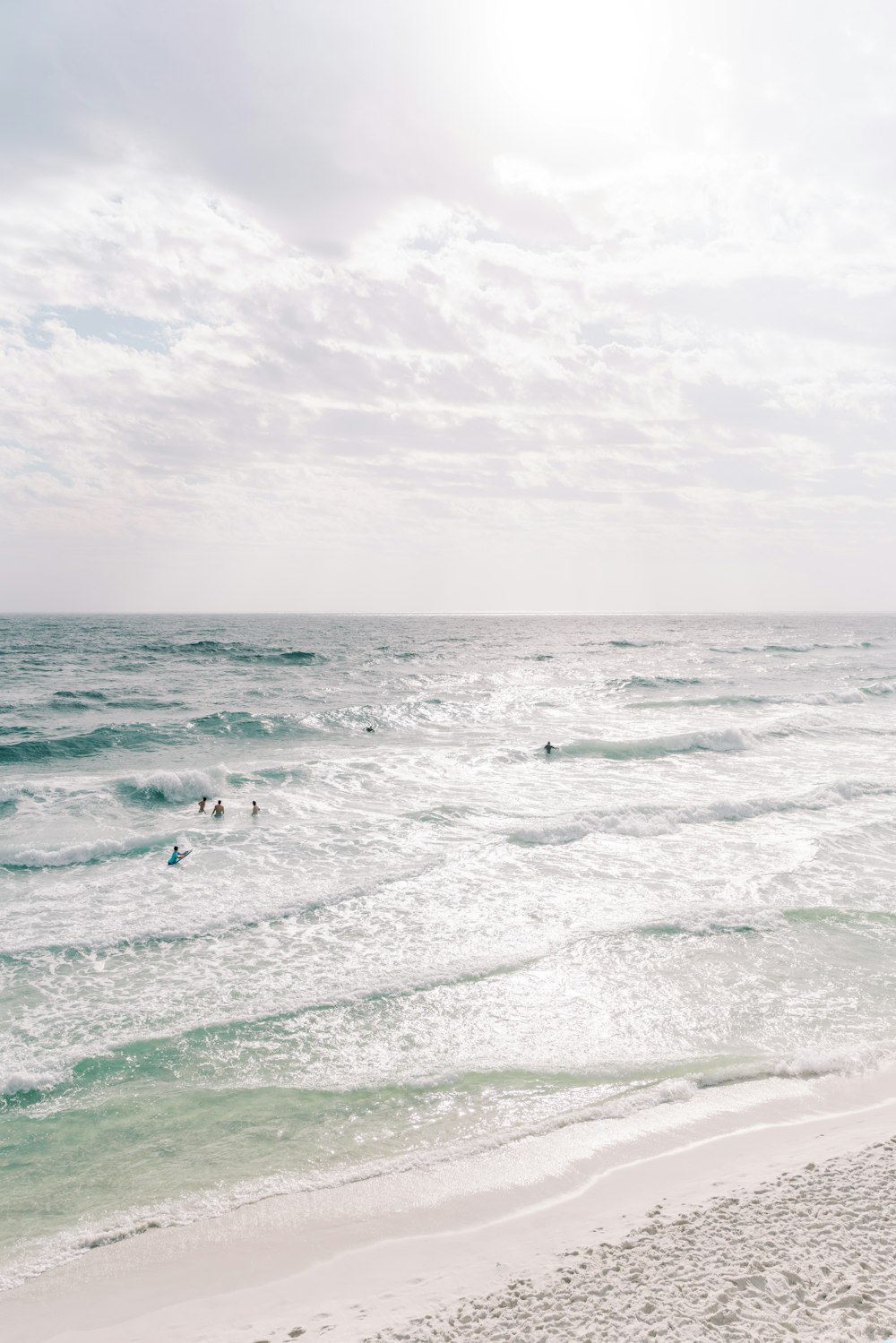 a group of people swimming in the ocean