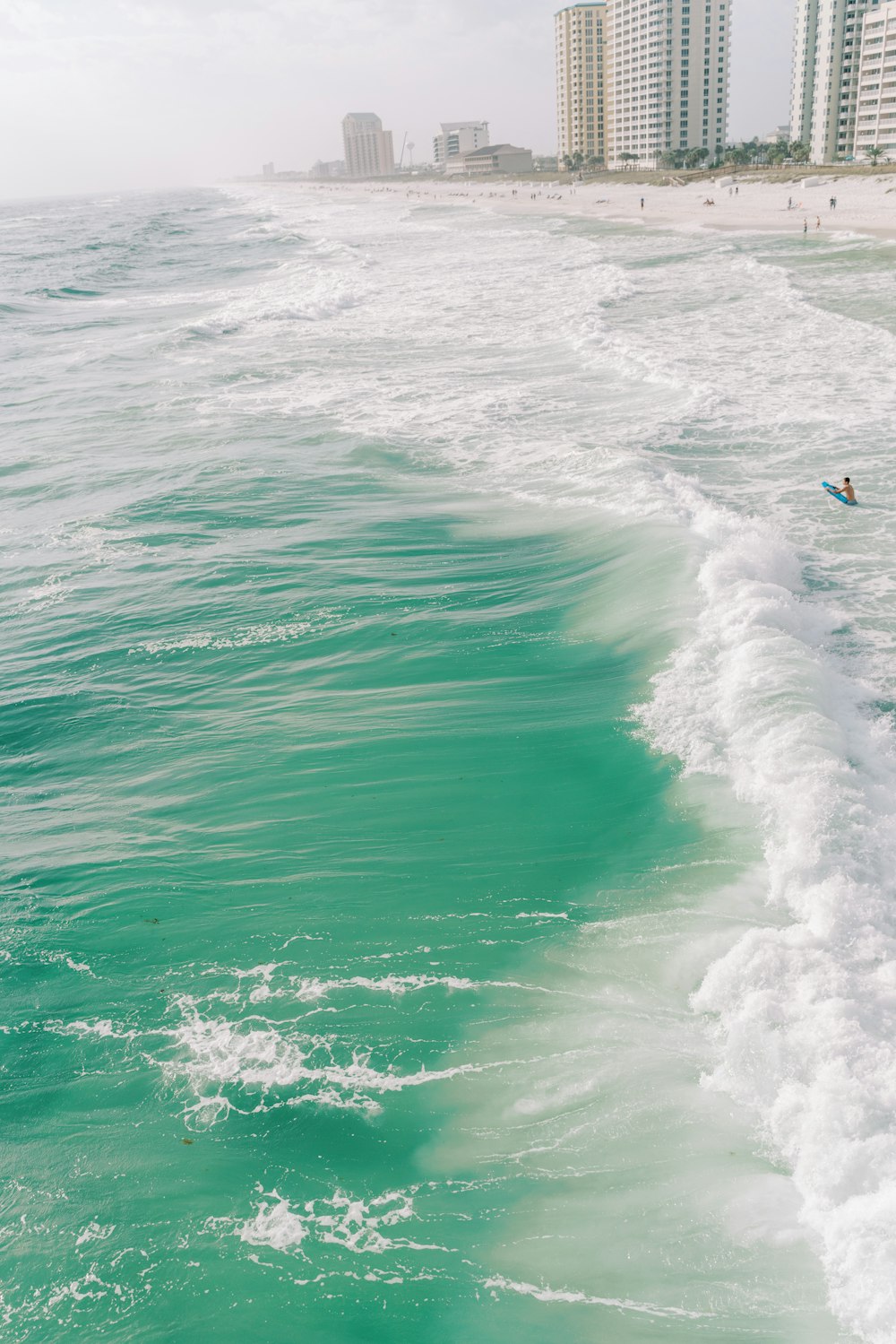 a man riding a surfboard on top of a wave in the ocean