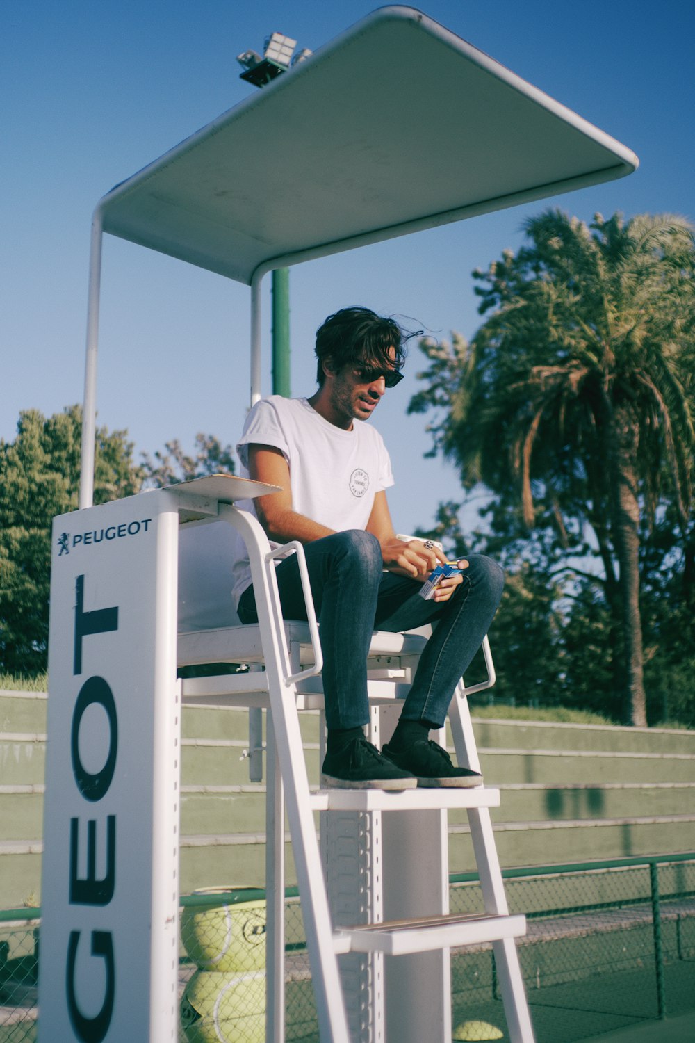 a man sitting on top of a white chair