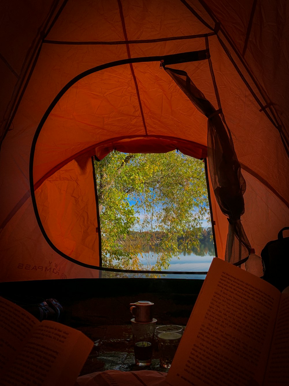 a view of a lake through a tent