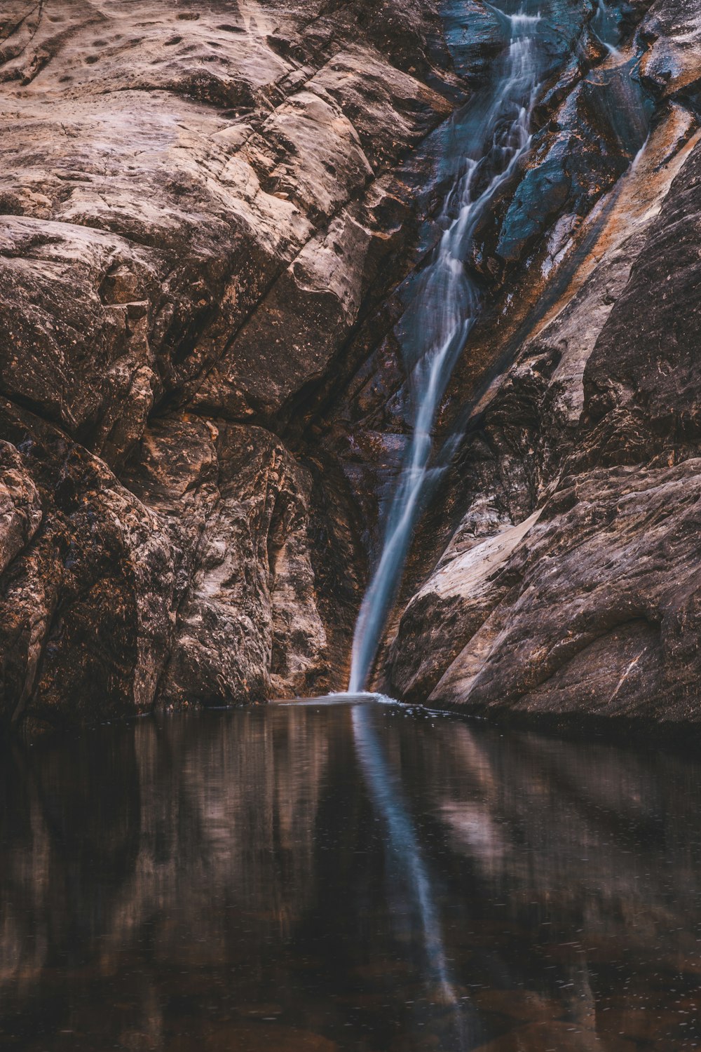 a small waterfall in the middle of some rocks