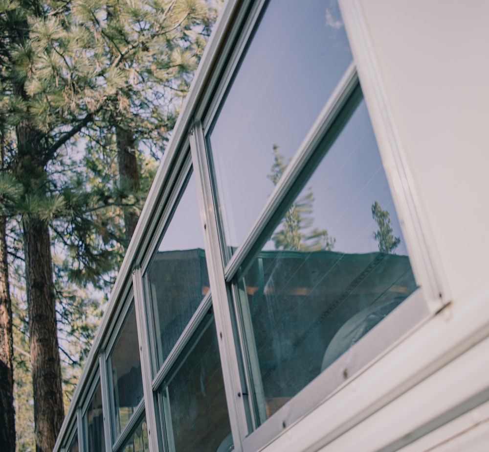 a close up of a window with trees in the background