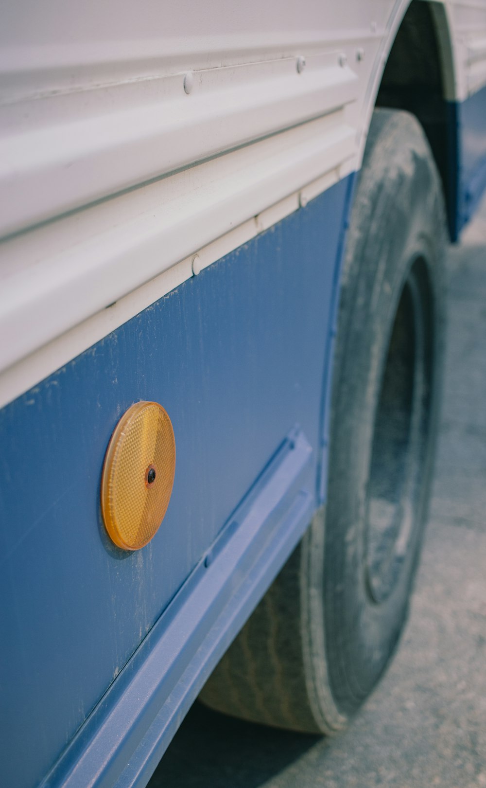 a close up of a blue and white bus