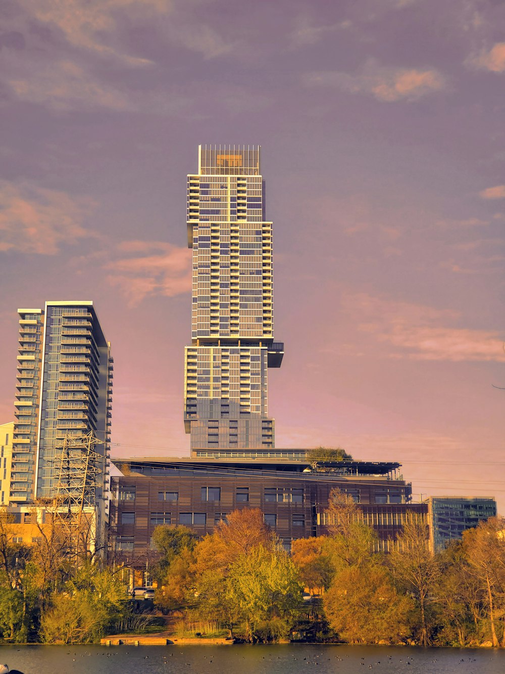 a very tall building sitting next to a body of water