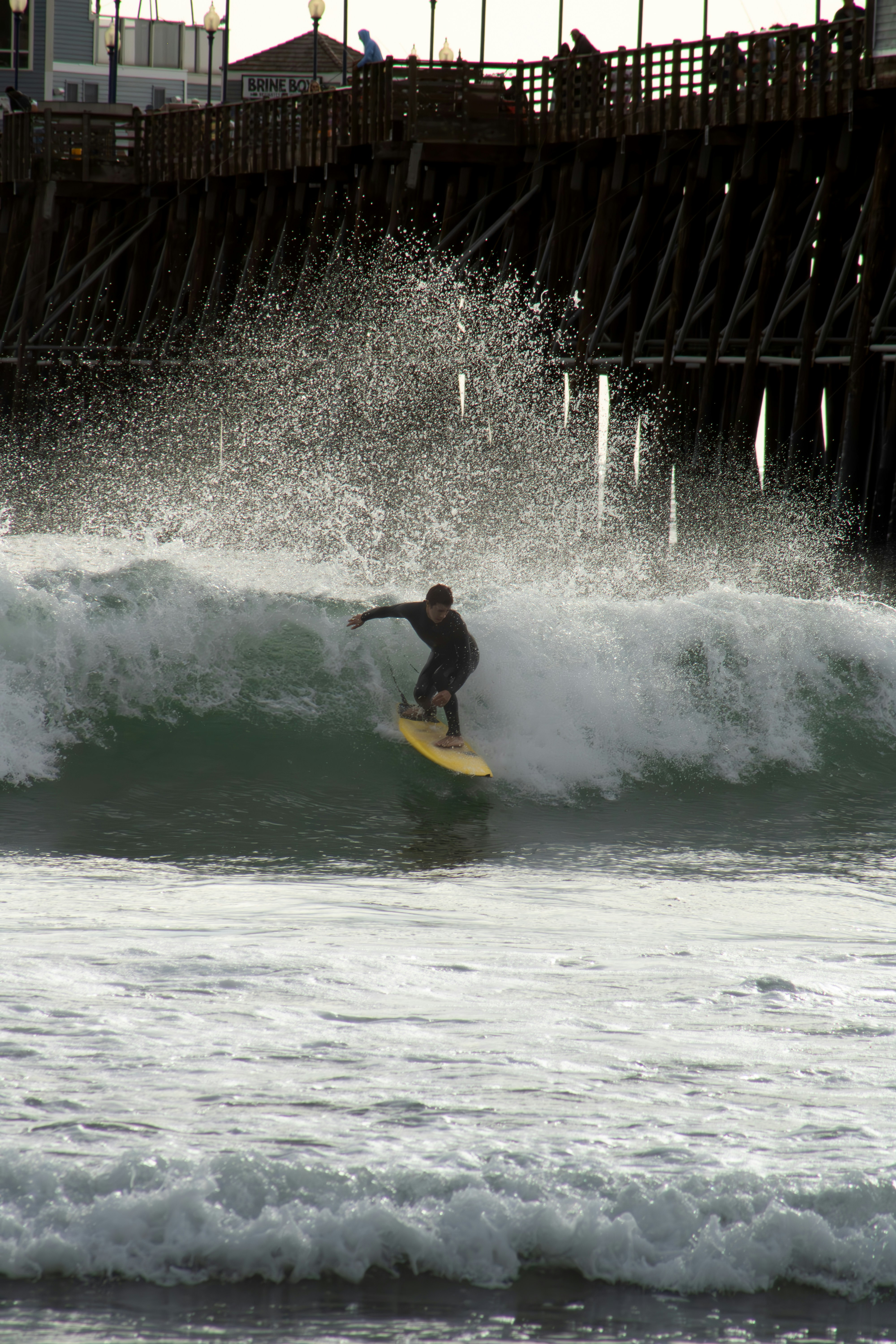 a man riding a wave on top of a surfboard