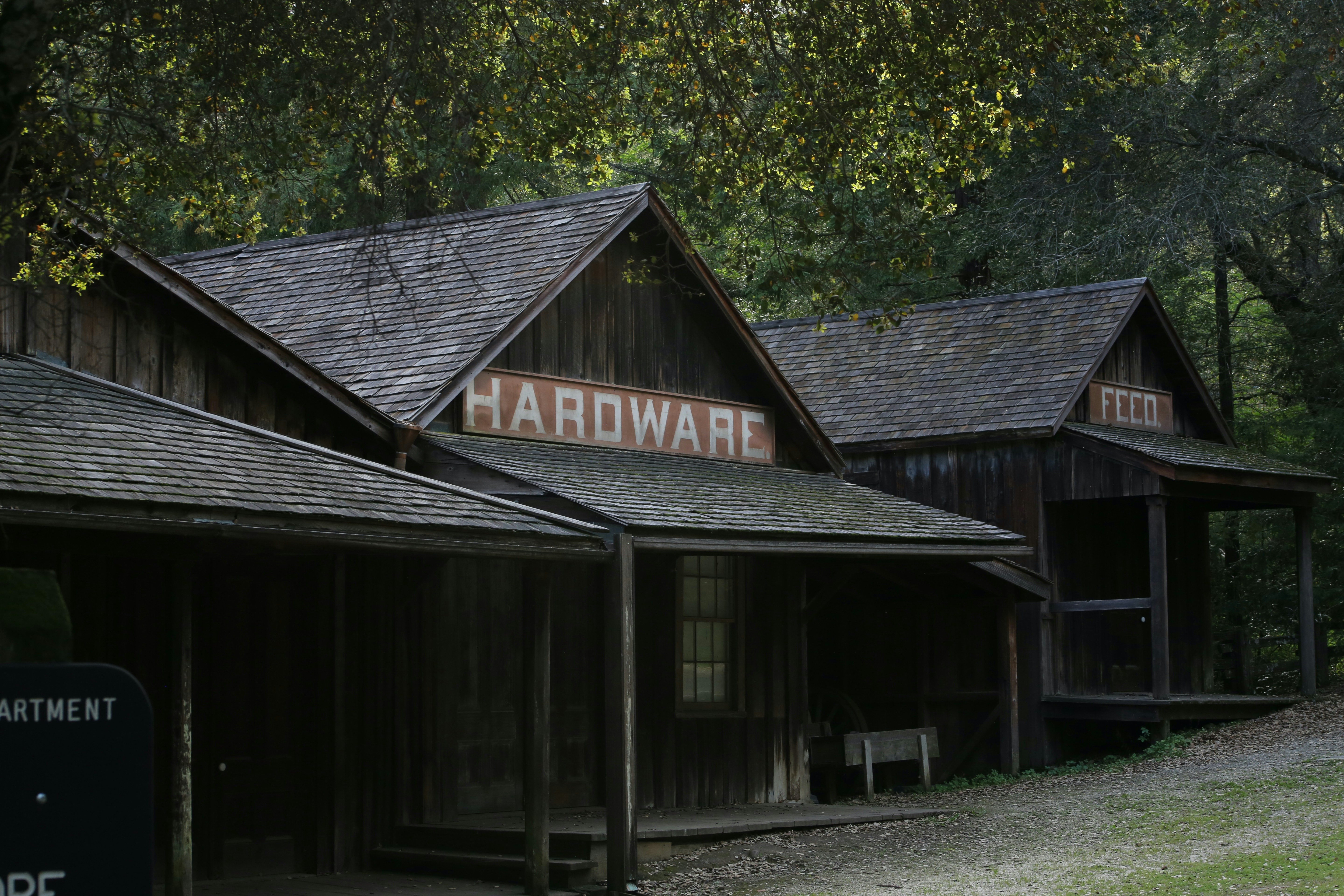 A wooden building with a sign that says hardware