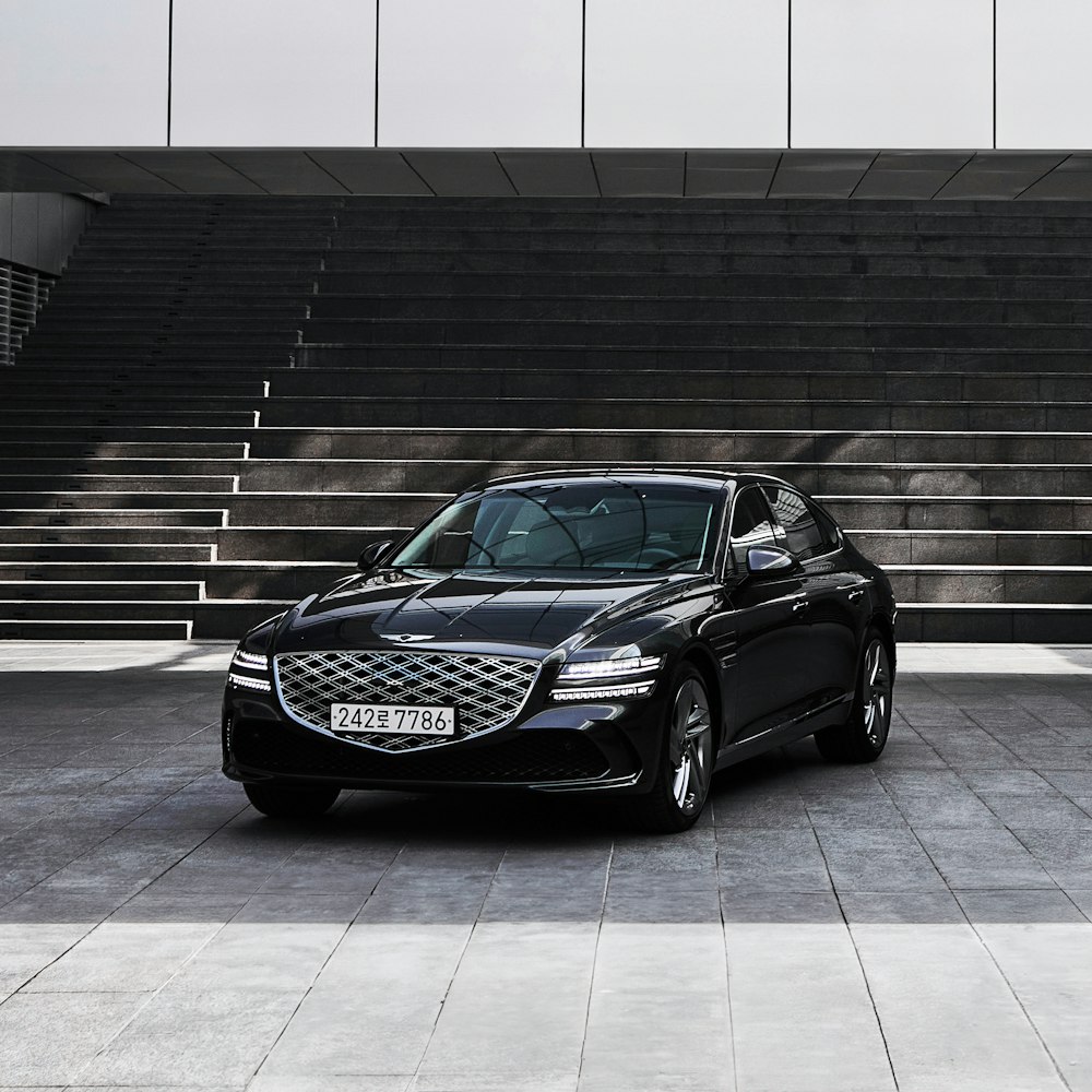 a black car parked in front of a building