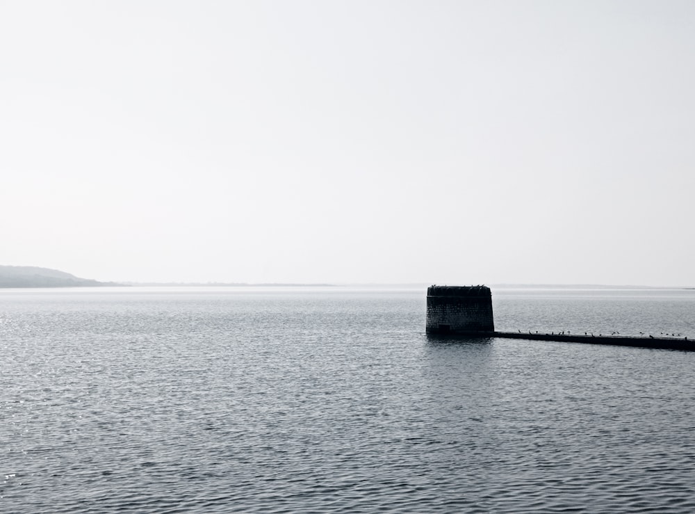 a large body of water with a buoy in the middle of it