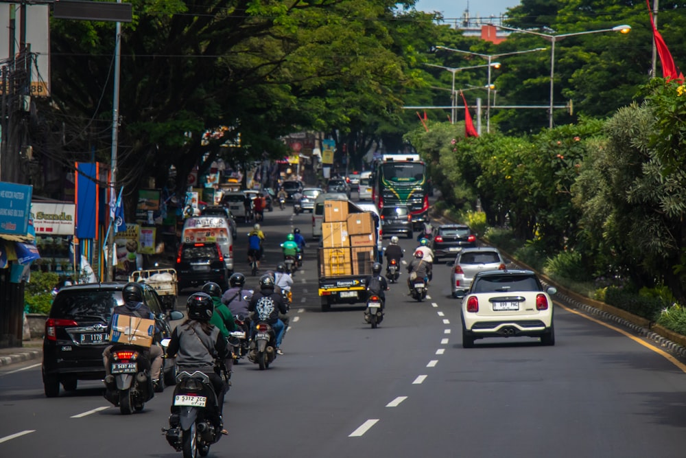 a group of people riding motorcycles down a street