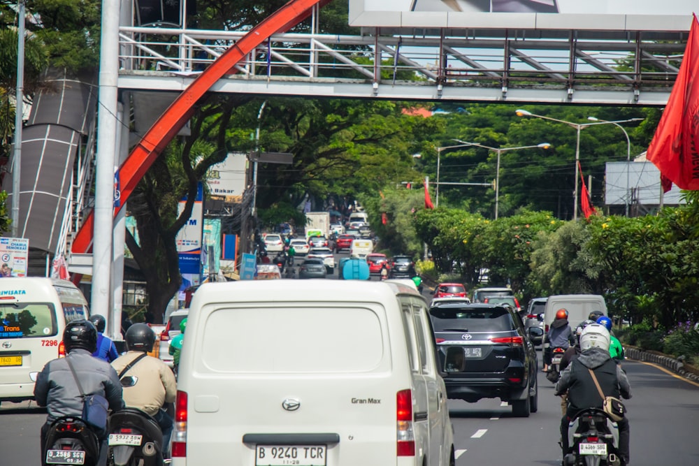 a group of people riding motorcycles down a street