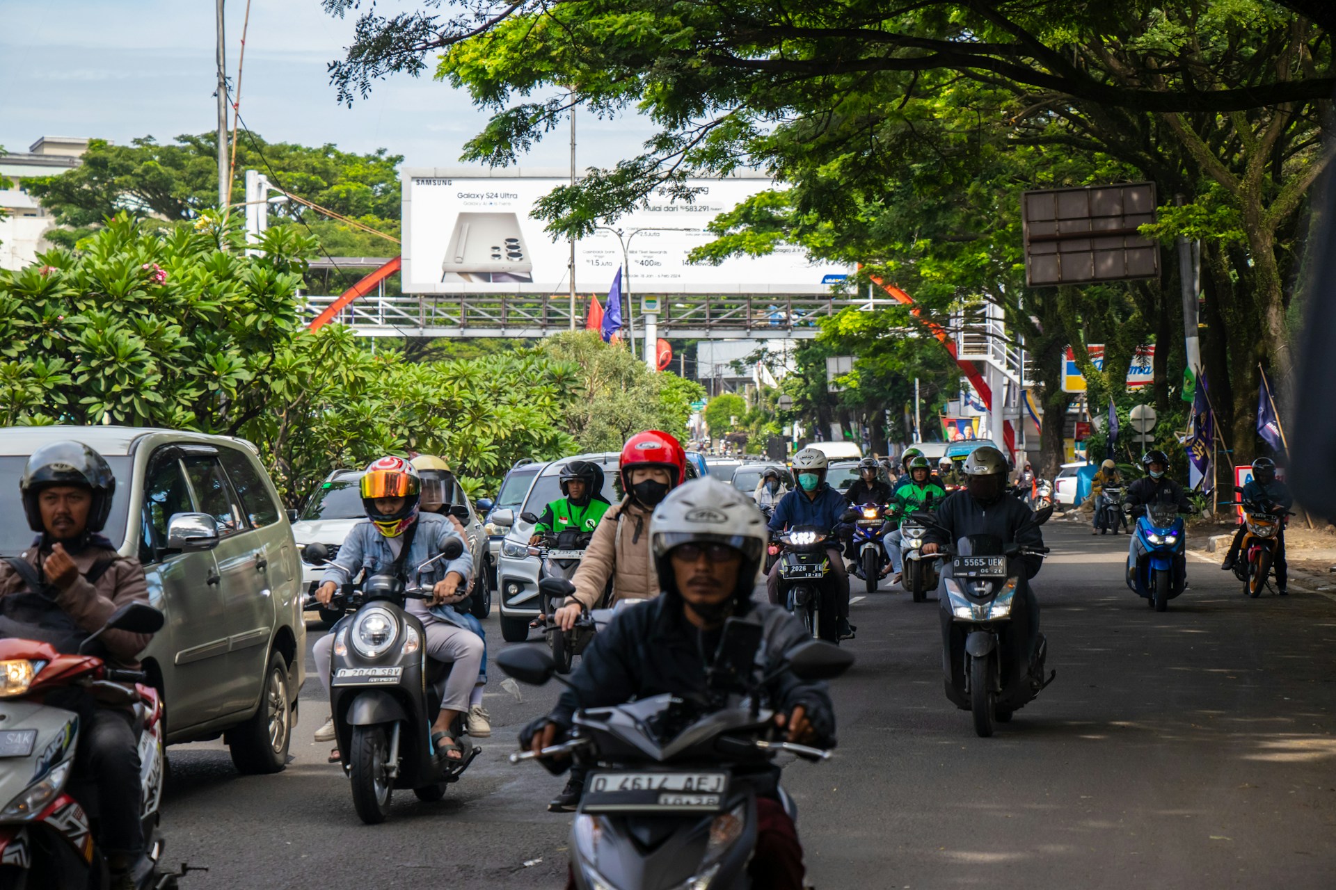 a group of people riding motorcycles down a street
