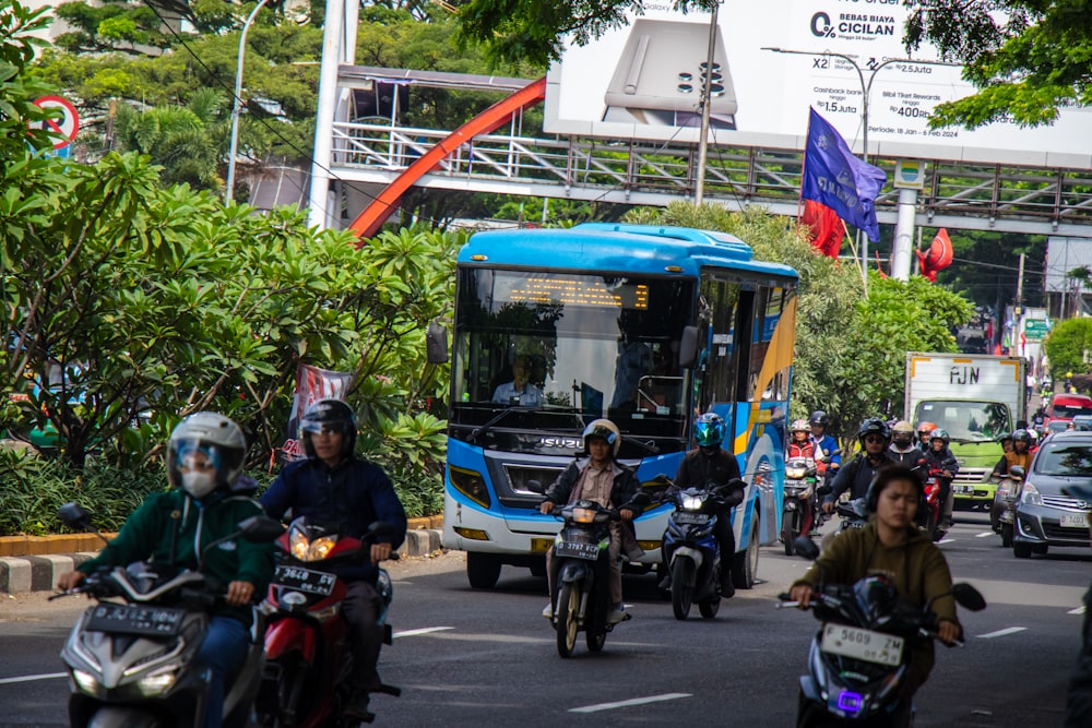 a group of people riding motorcycles down a street