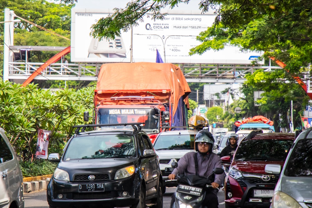 a man riding a motorcycle down a busy street