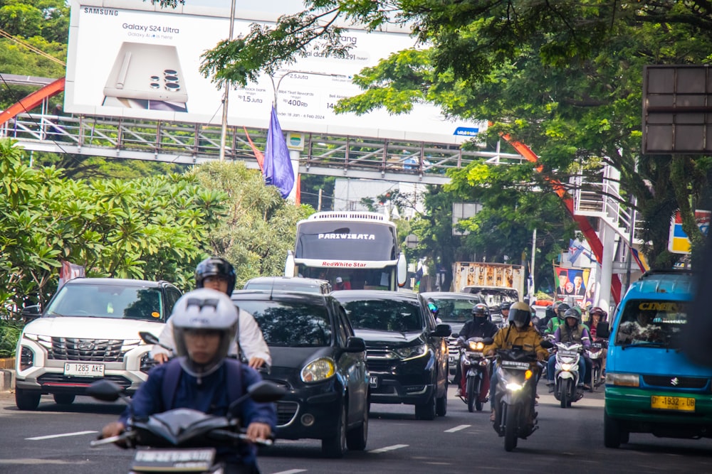 a group of people riding motorcycles down a street