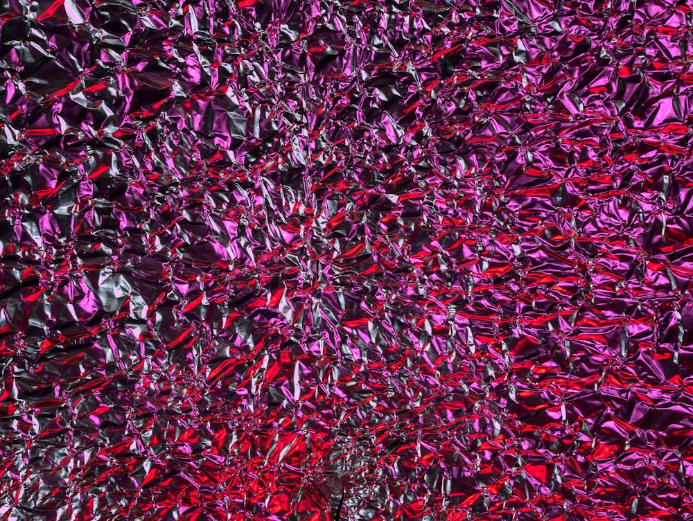 a red and purple abstract background with many small pieces of glass