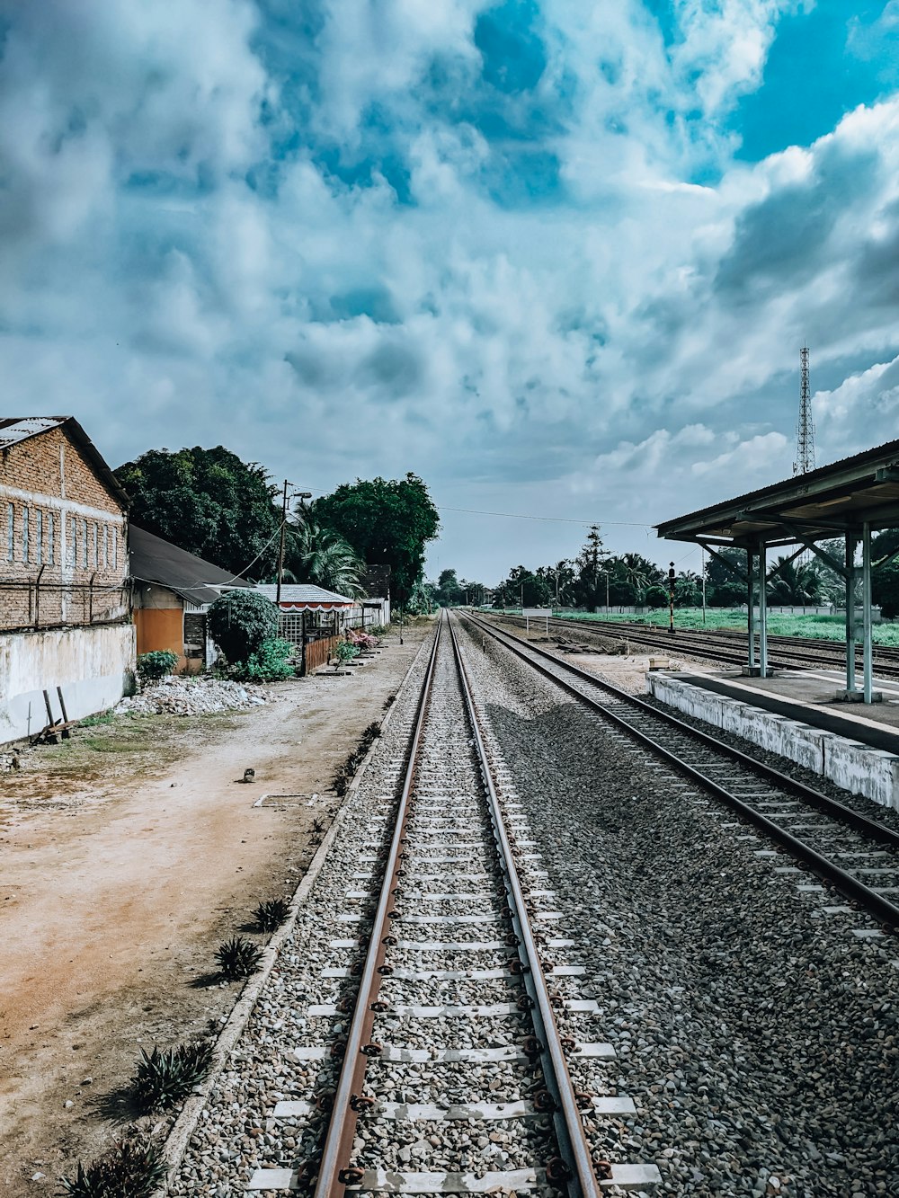 a train track with a building in the background