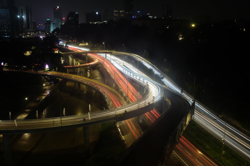 a long exposure photo of a highway at night