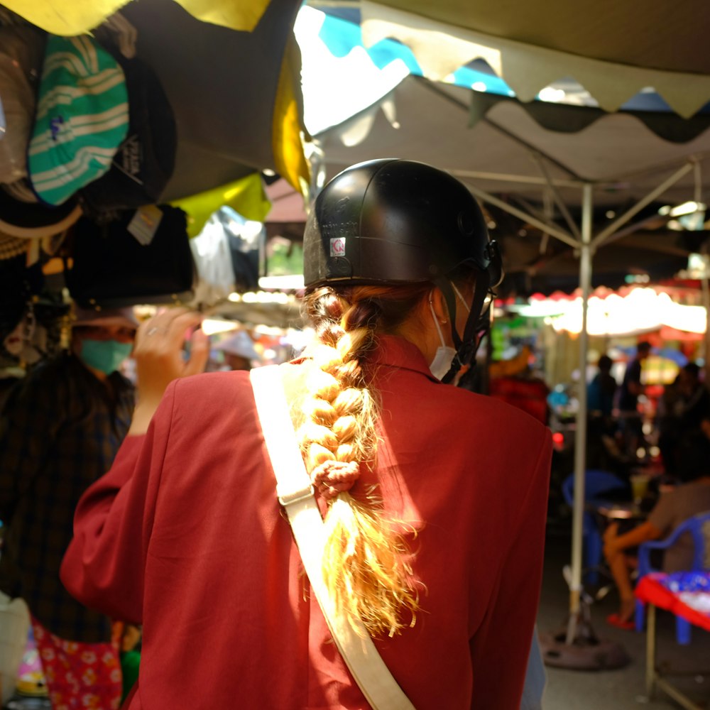 a person with a helmet and a long braid