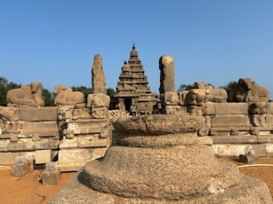 a group of stone statues in front of a blue sky