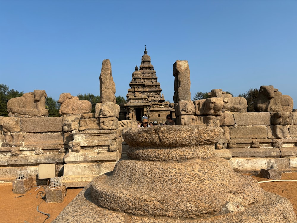 a group of stone statues in front of a blue sky