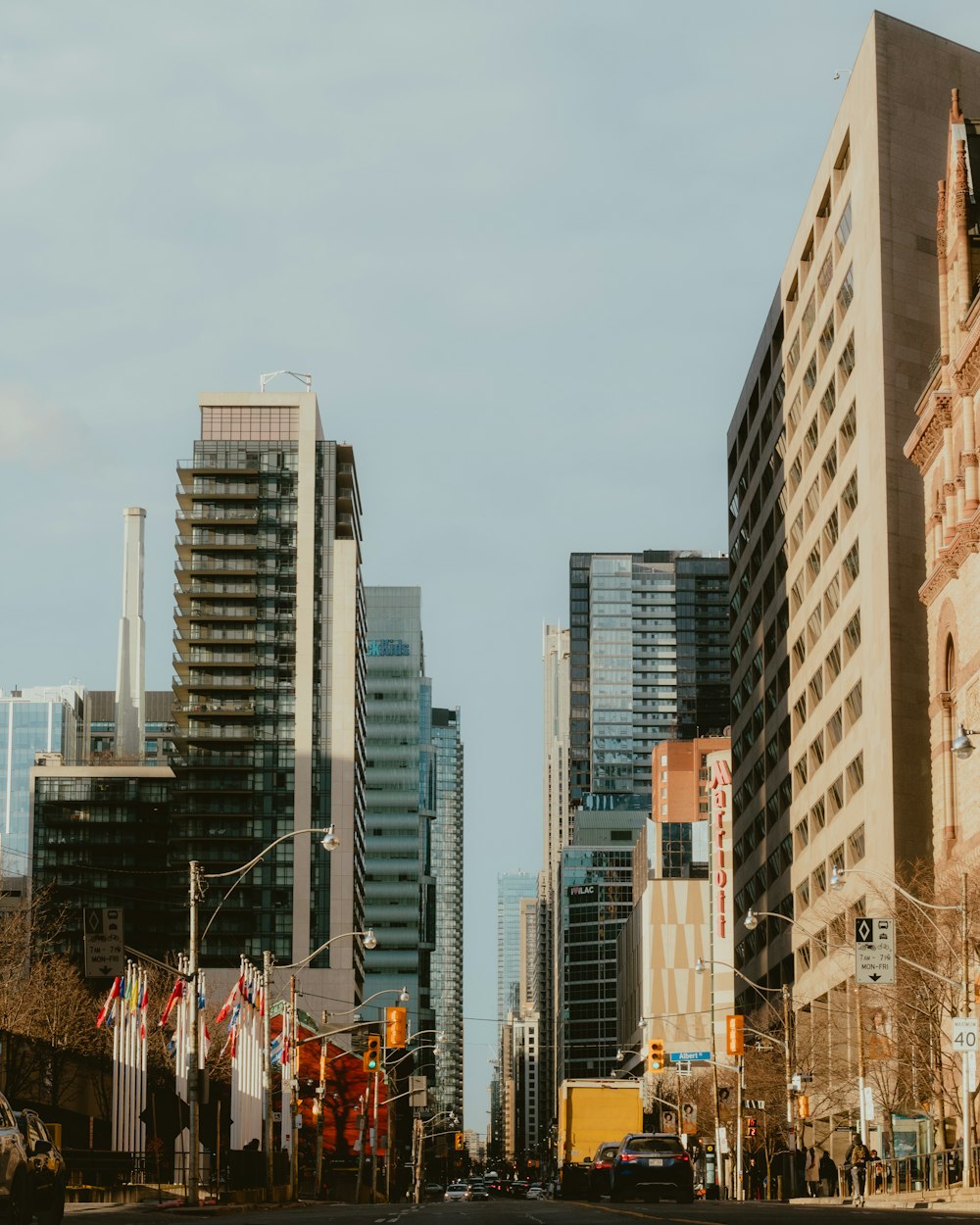 a city street with tall buildings in the background