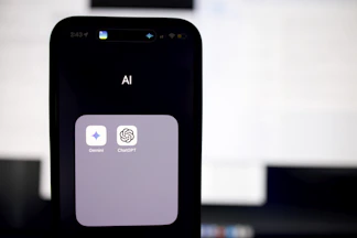 a close up of a cell phone with an ai button