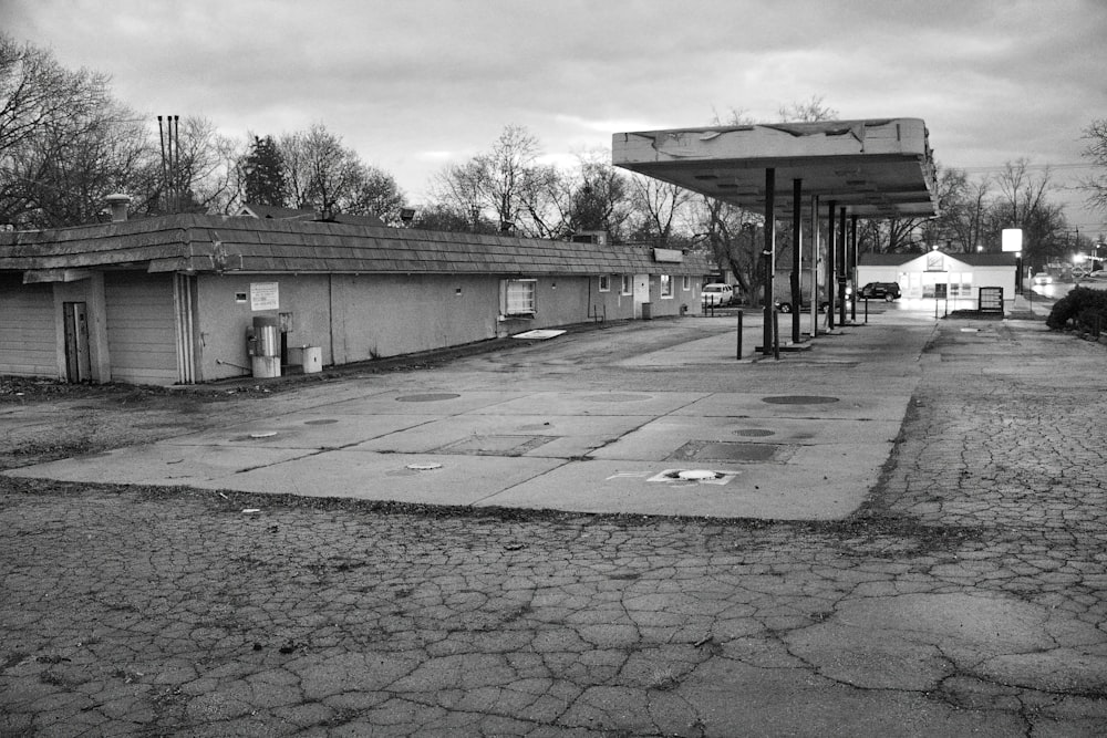 a black and white photo of an empty gas station