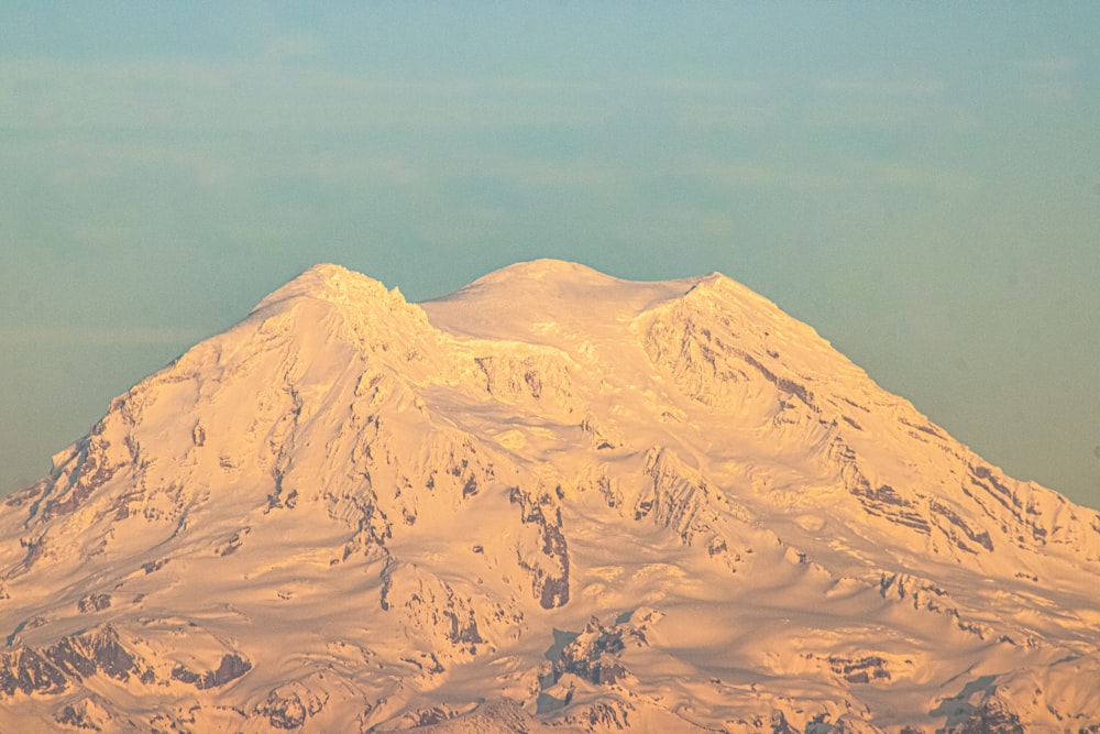 a large snow covered mountain in the distance