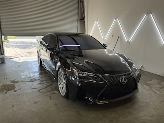 a black car is parked in a garage