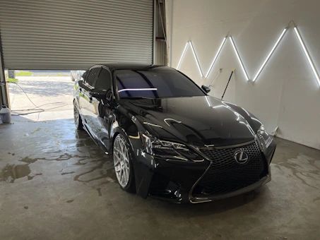 a black car is parked in a garage