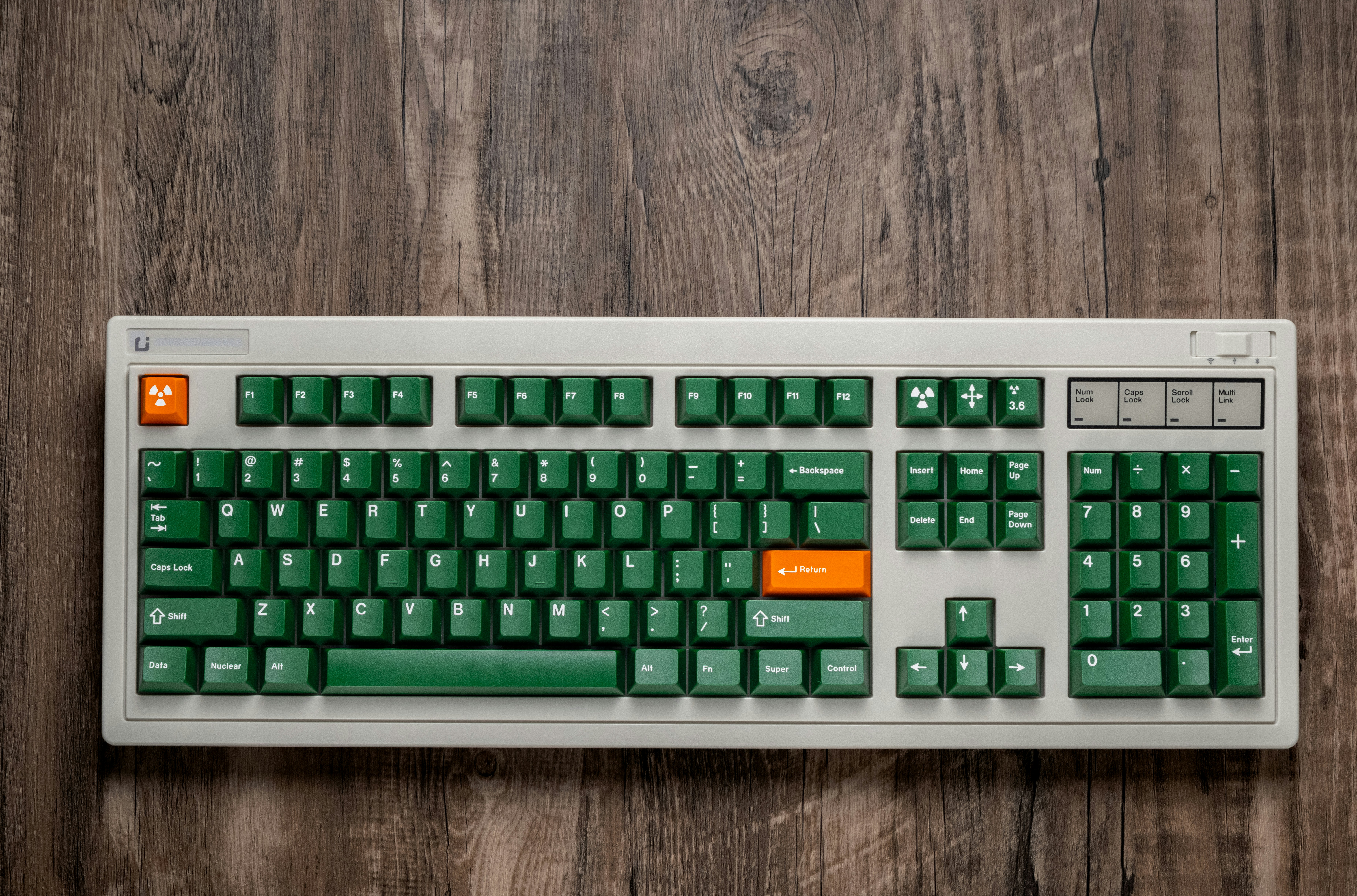 a computer keyboard sitting on top of a wooden table