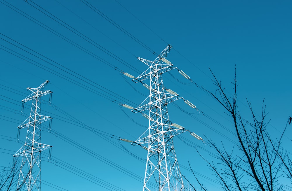 a group of power lines with a blue sky in the background