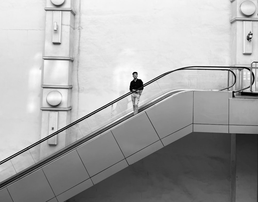 a man standing on an escalator in a building