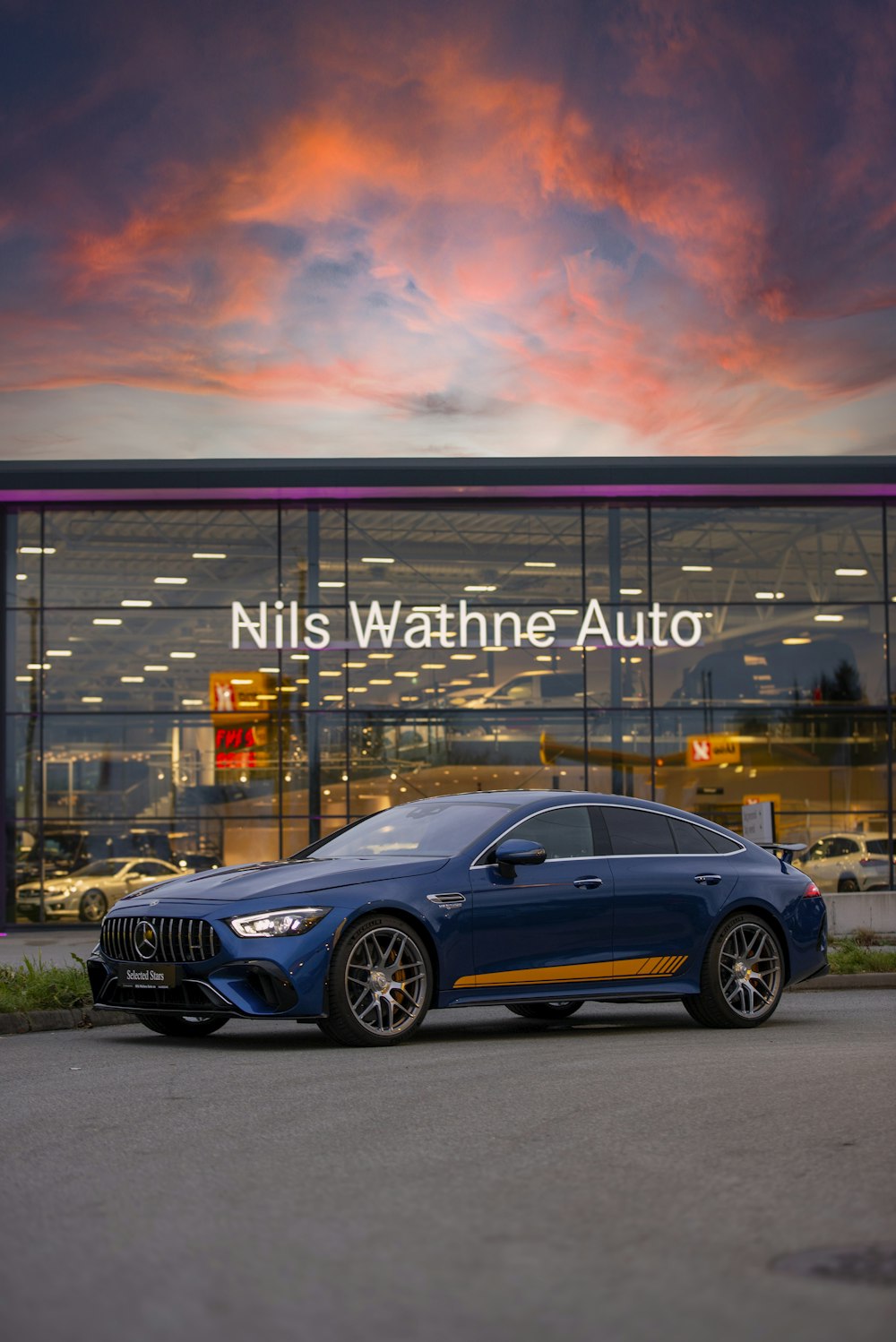 a blue car parked in front of a building