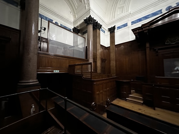 a large room with wooden floors and pillars