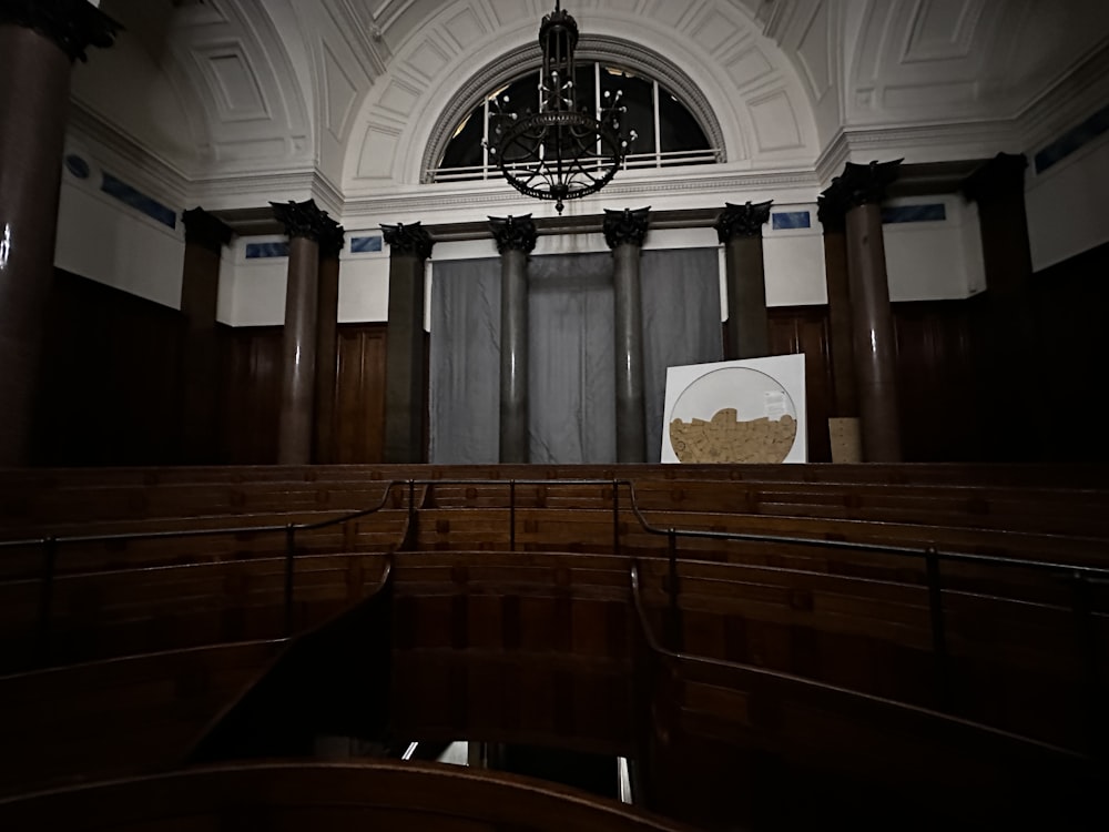 an empty church with a chandelier hanging from the ceiling