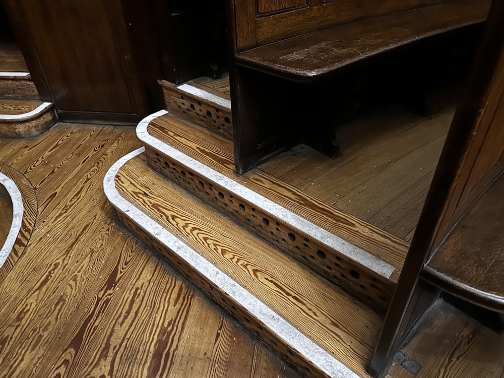 a close up of a set of stairs on a wooden floor