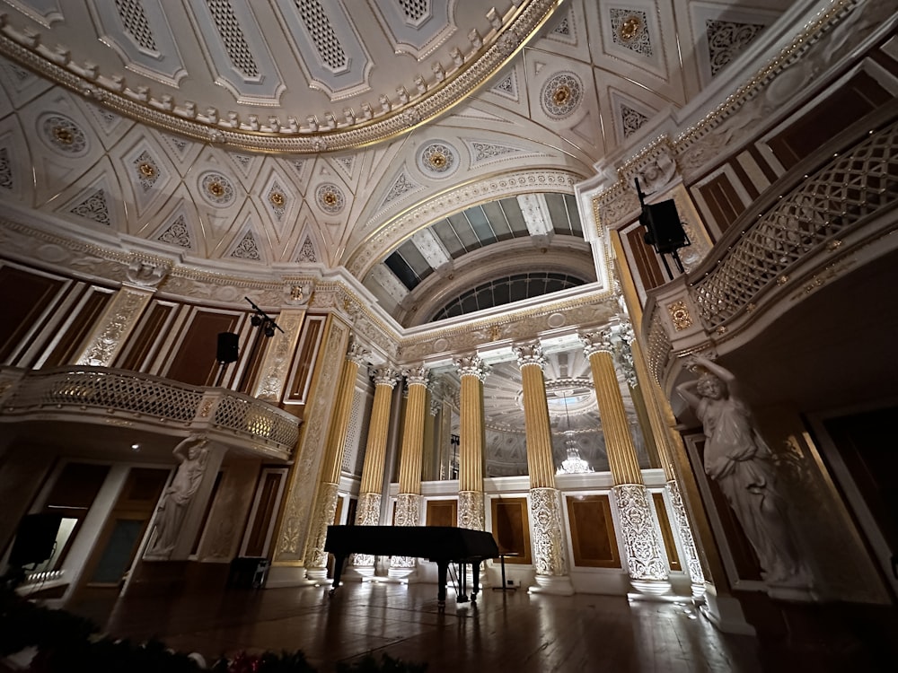 a grand piano sits in a large room