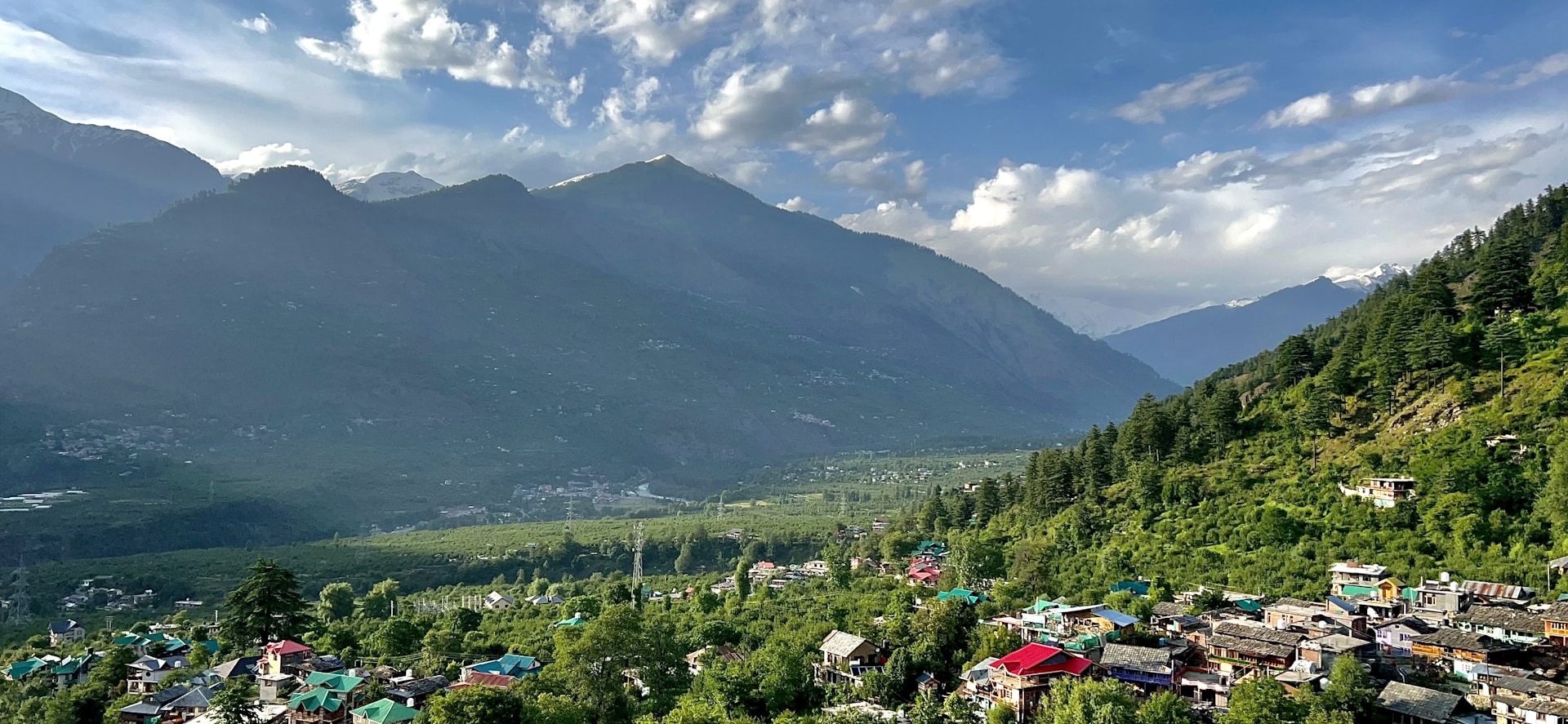 a scenic view of a village in the mountains
