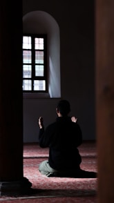 a person sitting on the floor in a room