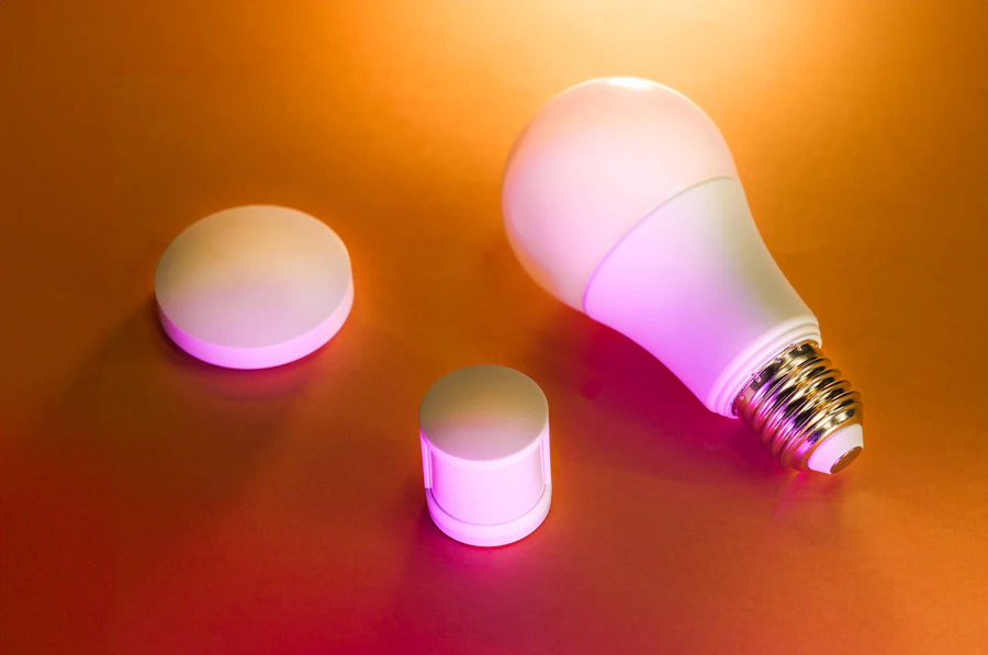 Smart light bulb and wireless controls glowing on a table