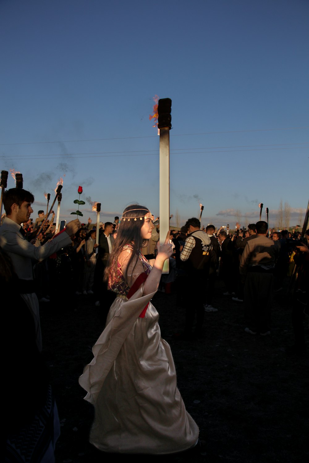 a woman in a white dress and a crowd of people