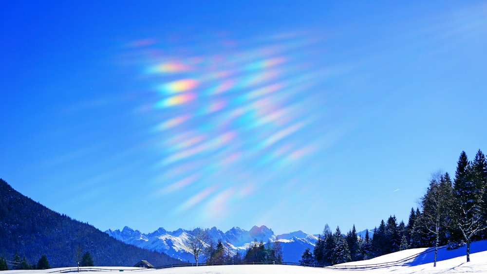 the sun is shining brightly over a snowy landscape